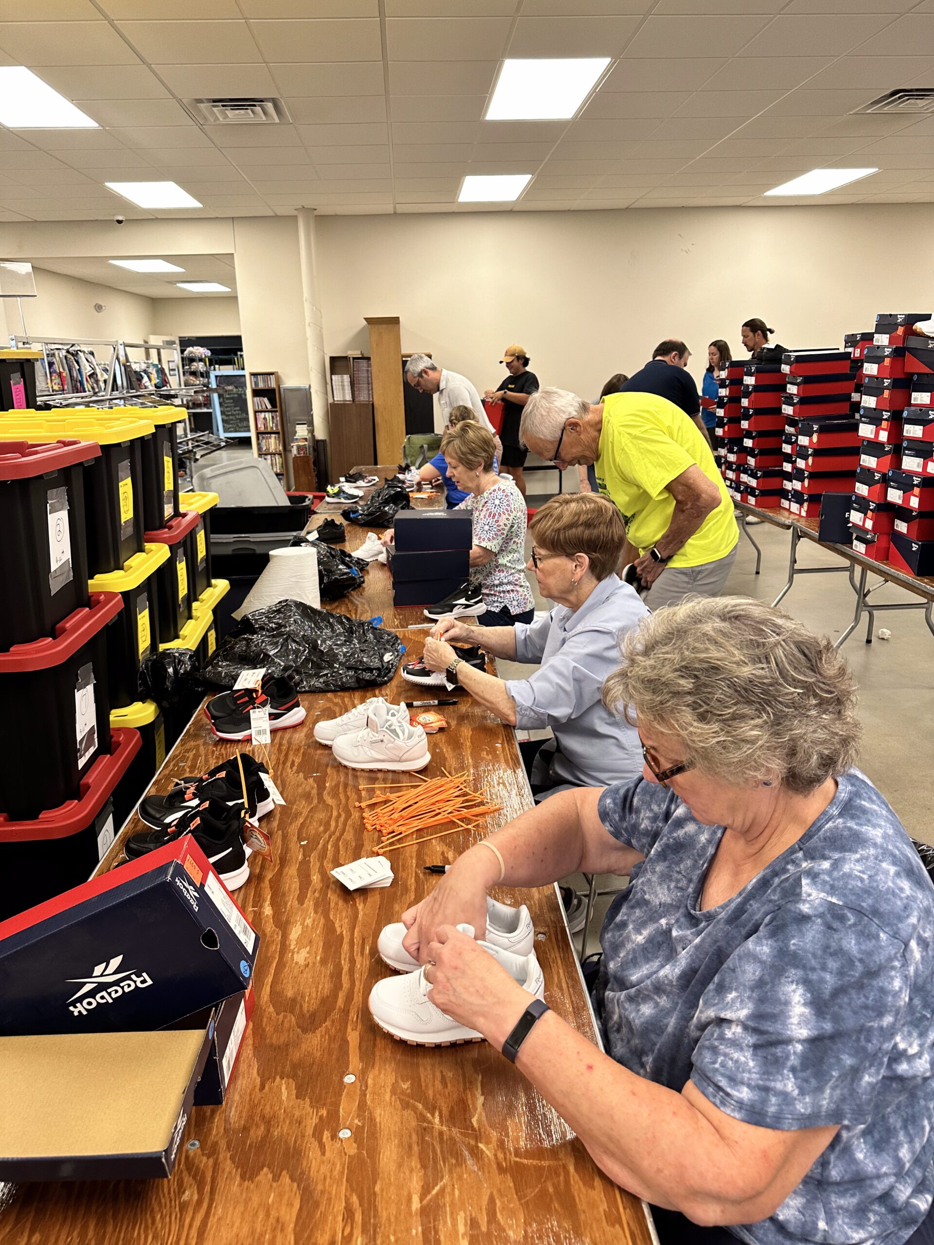Volunteers tagging shoes for Sneakers with Soul