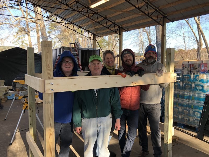 The ERT team stands next to a bunk bed they have made at a recovery site