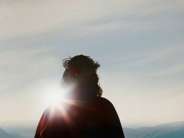 Photo of risen Christ facing the light of day after emerging from the tomb.