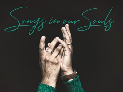 Visual of hands lifted in worship along with the words, Songs in Our Souls.
