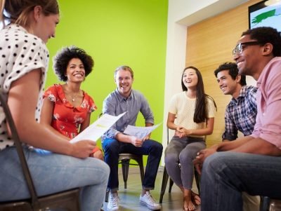 Photo of a group discussion with young adults in a semi-circle.