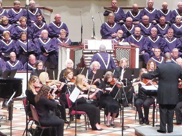 Concert with choir members and orchestra.