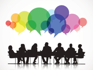 A group of silhouetted figures gather at a table to share their ideas, represented as a rainbow of speech bubbles.
