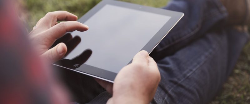 Young man surfing internet on a tablet.