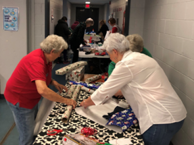 Volunteers wrapping at LifeWise StL Holiday Mart