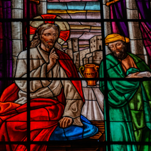 Stained glass representation of Jesus conversing with a man