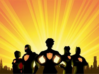A silhouette style illustration of a team of superheroes with female leader with city skyline and sunburst in the background. Wide space available for your copy.