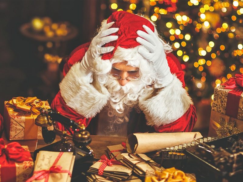 Photo of Santa with head in his hands, clearly stressed.