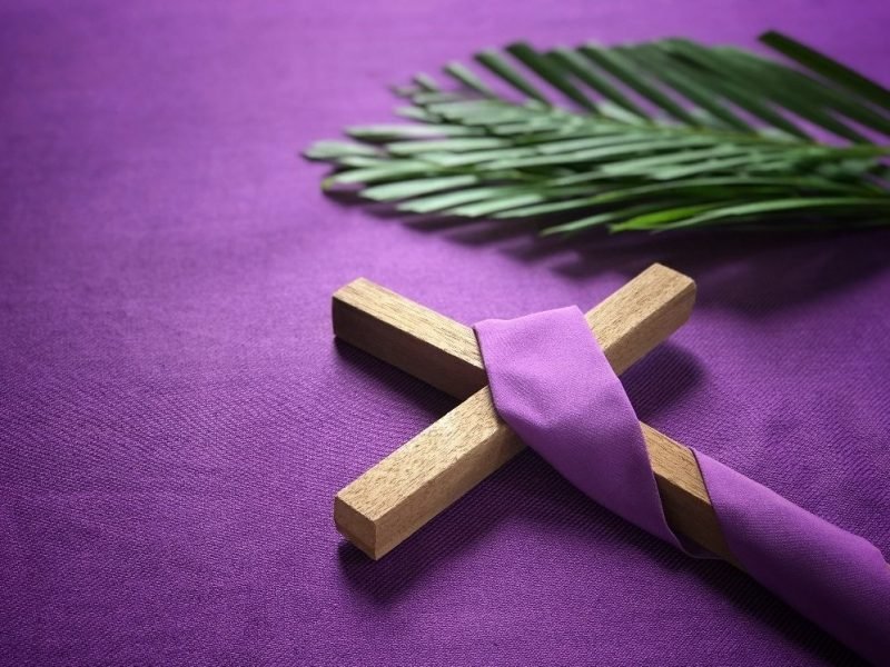 Photo of wooden cross wrapped in purple.